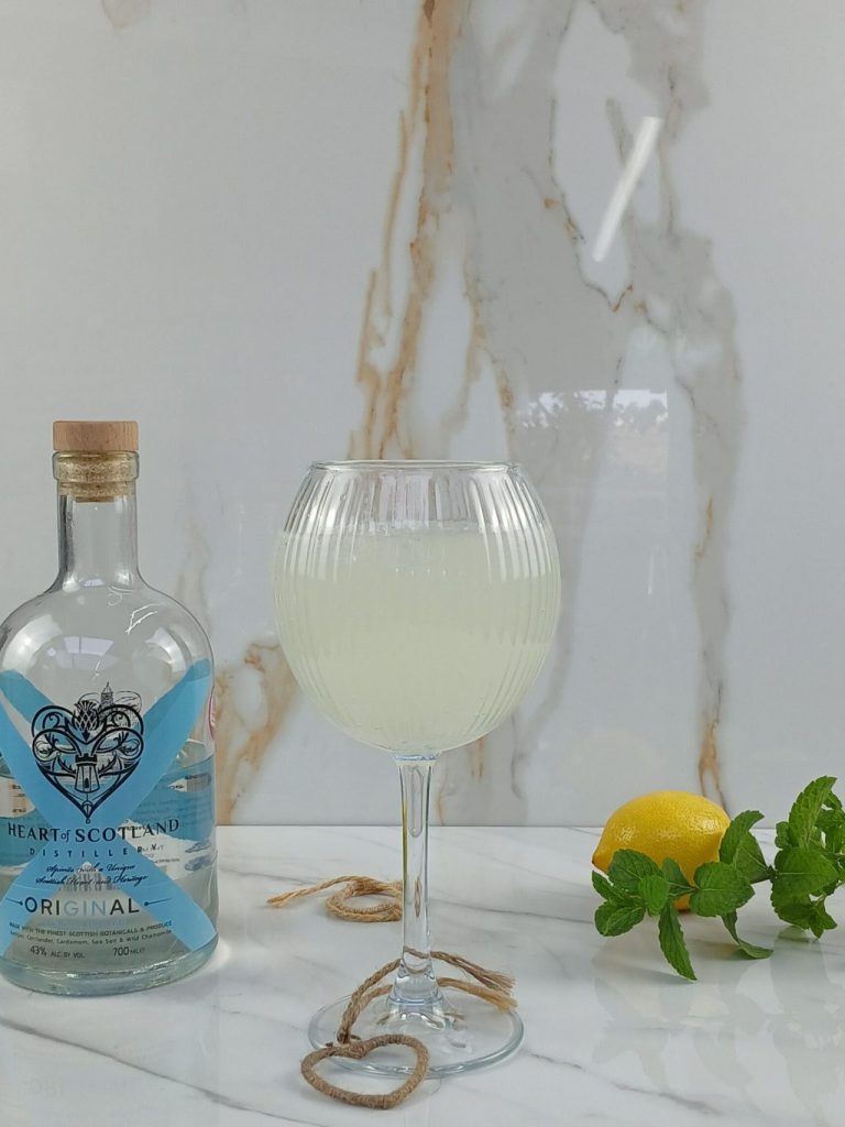 Heart of Scotland Lemon Smash cocktail in a balloon glass with mint garnish